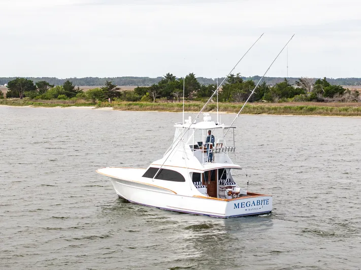 Megabite Yacht Photos Pics Custom Carolina Scarborough 1984 boat named "Megabite" cruising on a calm waterway.