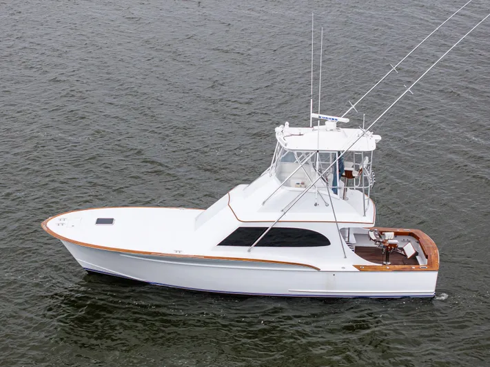 Megabite Yacht Photos Pics 1984 Custom Carolina Scarborough boat on water, featuring sleek design and fishing equipment.