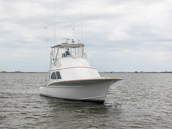 Megabite Yacht Photos Pics 1984 Custom Carolina Scarborough boat on calm water under cloudy sky.