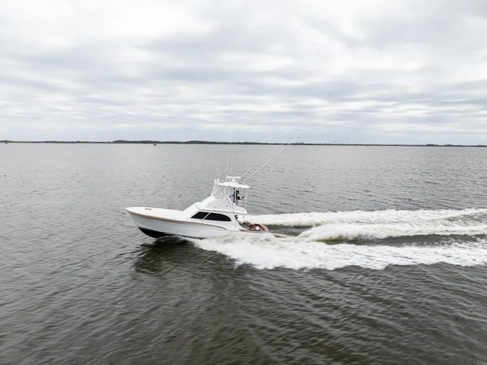 Megabite Yacht Photos Pics 1984 Custom Carolina Scarborough boat cruising on open water under cloudy skies.