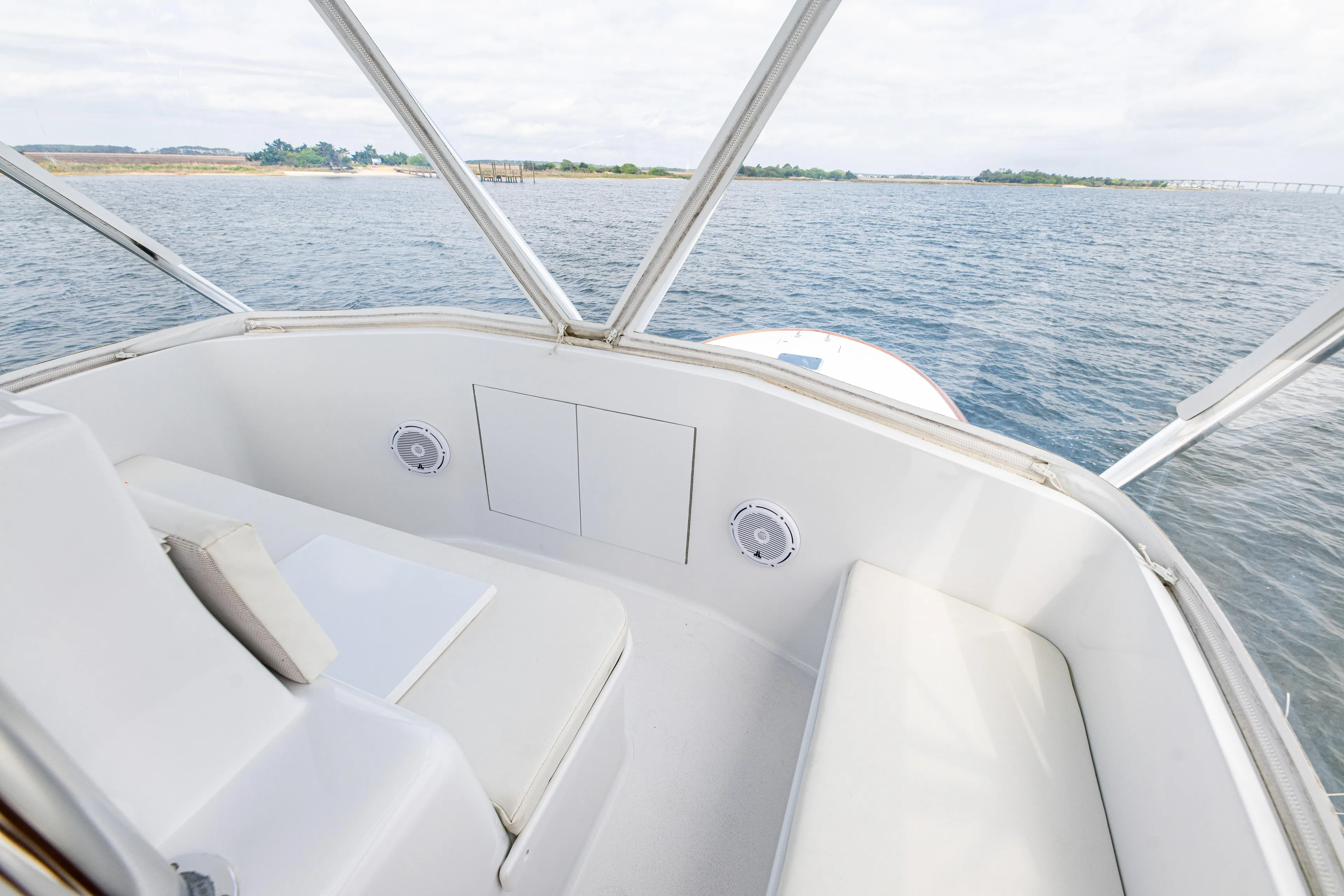 Megabite Yacht Photos Pics 1984 Custom Carolina Scarborough boat interior with white seating, overlooking calm waters.