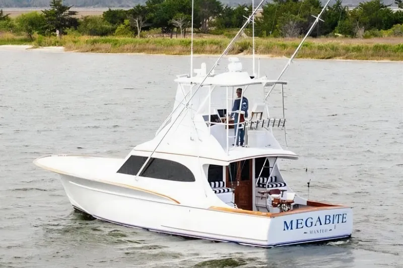 Megabite Yacht Photos Pics 1984 Custom Carolina Scarborough yacht "Megabite" cruising on water near a grassy shoreline.