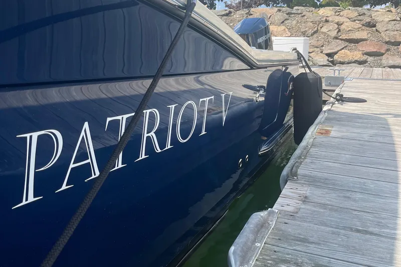  Yacht Photos Pics 2024 Scout 330 LXF boat named "Patriot V" docked at a marina.