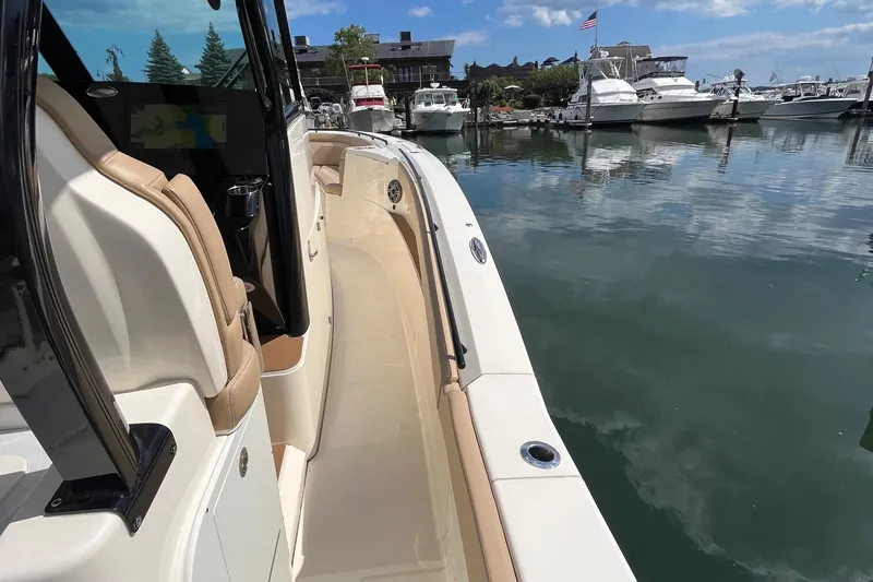  Yacht Photos Pics 2024 Scout 330 LXF boat docked in a marina with clear skies.