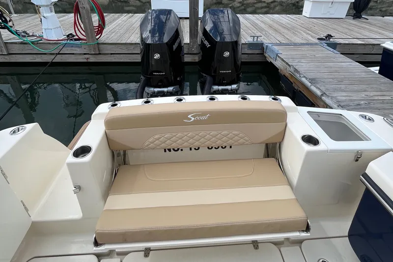  Yacht Photos Pics 2024 Scout 330 LXF boat with dual engines and beige seating at a dock.