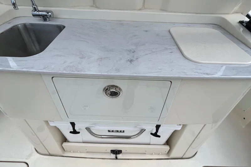  Yacht Photos Pics 2024 Scout 330 LXF boat kitchen with sink and marble countertop.