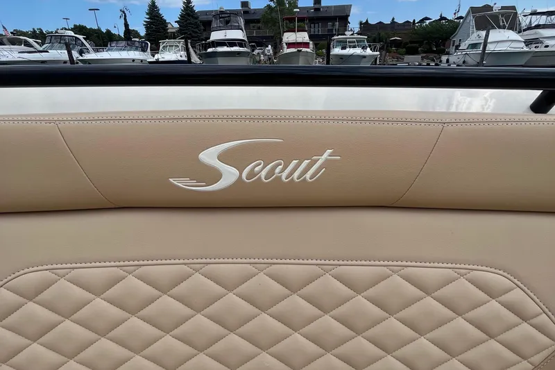  Yacht Photos Pics 2024 Scout 330 LXF boat interior with quilted leather seating at marina.
