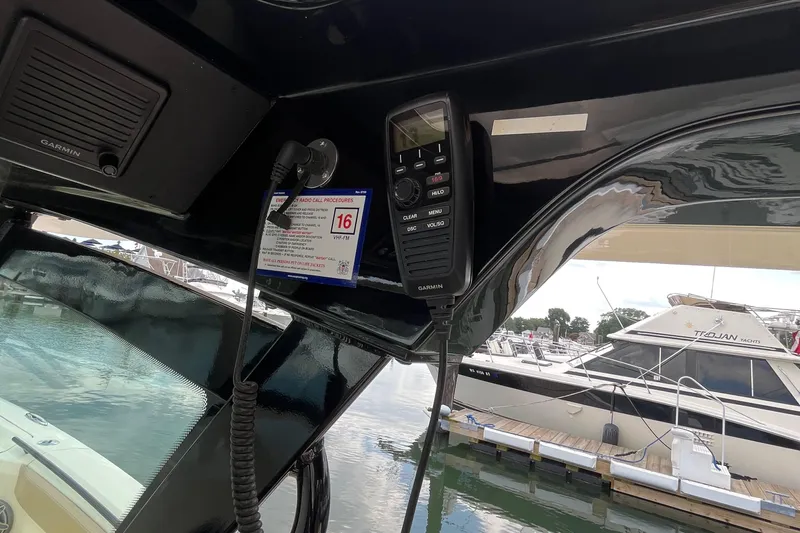  Yacht Photos Pics 2024 Scout 330 LXF boat interior with radio and marina view.