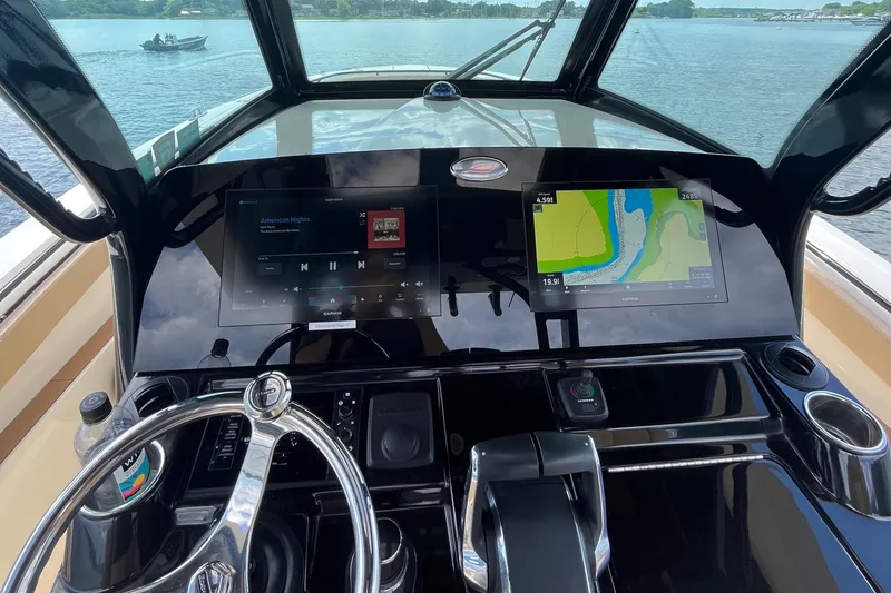  Yacht Photos Pics 2024 Scout 330 LXF boat dashboard with navigation and entertainment screens.