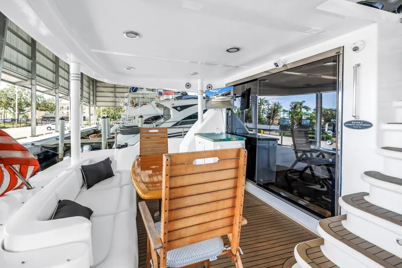  Yacht Photos Pics Luxurious 2000 Neptunus 65 Flybridge yacht interior with elegant seating and wooden accents.