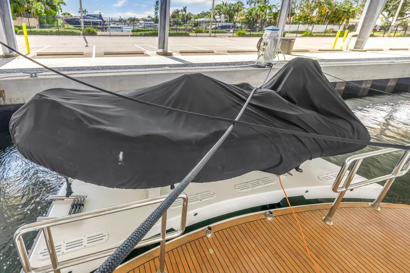  Yacht Photos Pics Covered Neptunus 65 Flybridge yacht docked, showcasing sleek design and modern features.