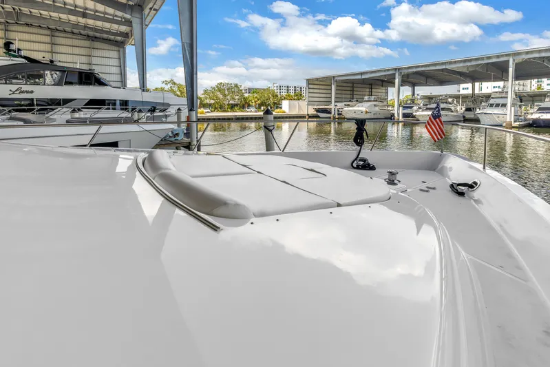  Yacht Photos Pics Neptunus 65 Flybridge 2000 yacht docked in marina with American flag.