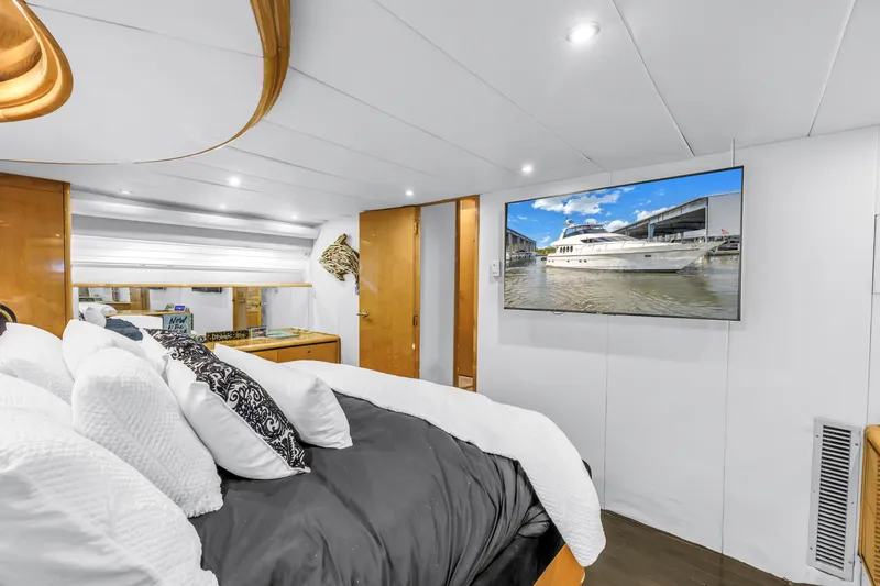 Yacht Photos Pics Luxurious Neptunus 65 Flybridge yacht bedroom with modern decor and wall-mounted TV, 2000 model.