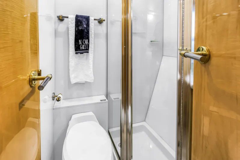  Yacht Photos Pics Luxurious bathroom on 2000 Neptunus 65 Flybridge yacht with modern fixtures and elegant design.