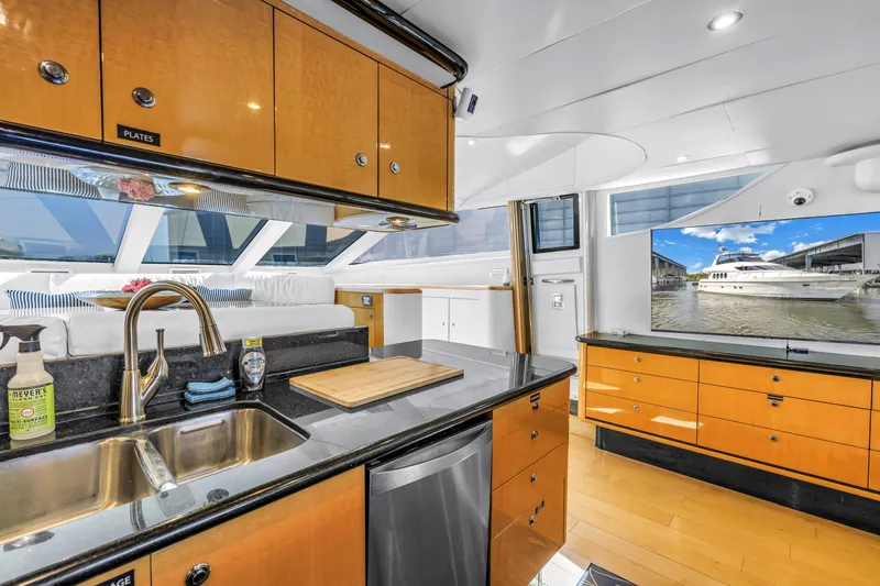  Yacht Photos Pics Luxurious Neptunus 65 Flybridge yacht interior with modern kitchen and scenic window view, 2000 model.