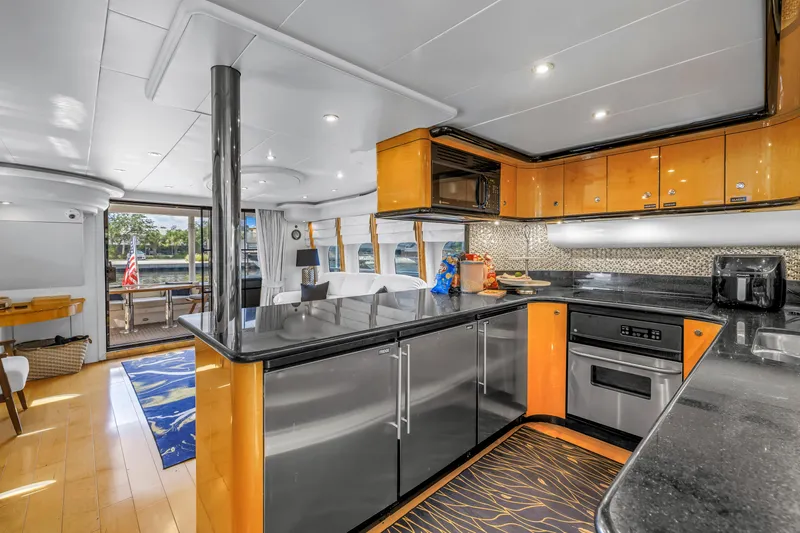  Yacht Photos Pics Luxurious interior of 2000 Neptunus 65 Flybridge yacht with modern kitchen and elegant design.