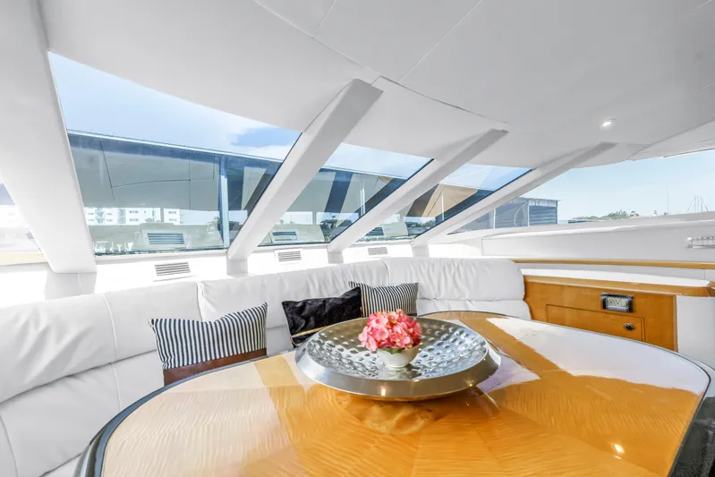  Yacht Photos Pics Luxurious interior of 2000 Neptunus 65 Flybridge yacht with elegant seating and table.