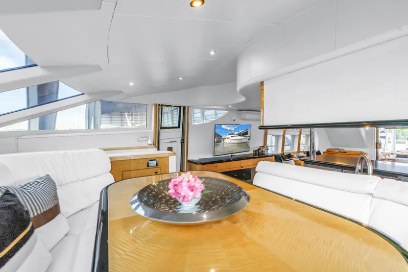  Yacht Photos Pics Luxurious interior of 2000 Neptunus 65 Flybridge yacht with elegant seating and modern amenities.
