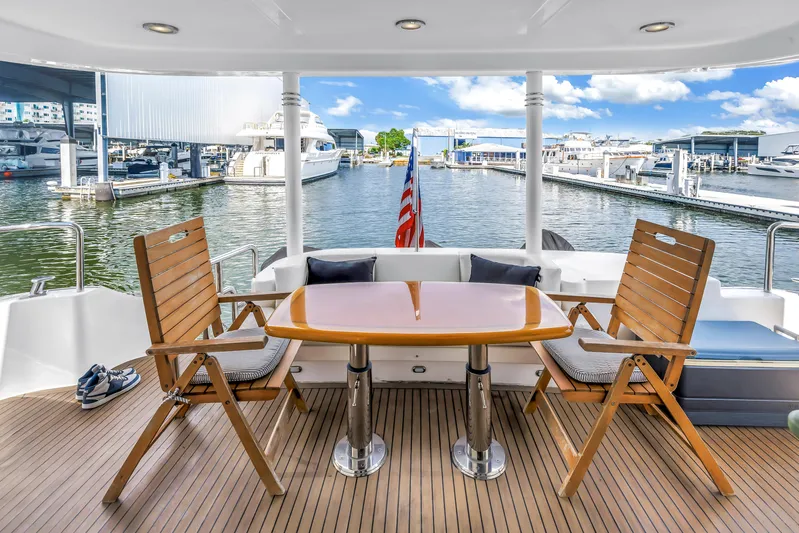  Yacht Photos Pics Outdoor seating on 2000 Neptunus 65 Flybridge yacht with marina view.