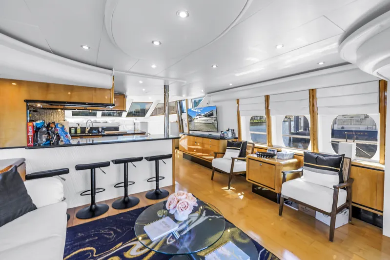  Yacht Photos Pics Luxurious interior of 2000 Neptunus 65 Flybridge yacht with modern seating and elegant decor.