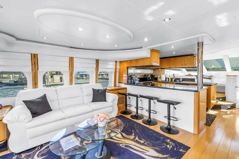  Yacht Photos Pics Luxurious interior of 2000 Neptunus 65 Flybridge yacht with modern kitchen and elegant seating area.