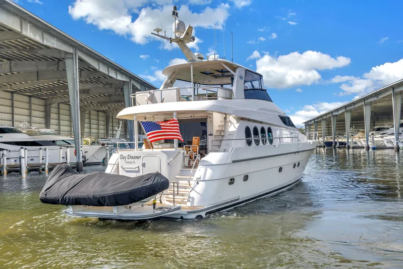  Yacht Photos Pics Luxury 2000 Neptunus 65 Flybridge yacht docked in marina under blue sky.