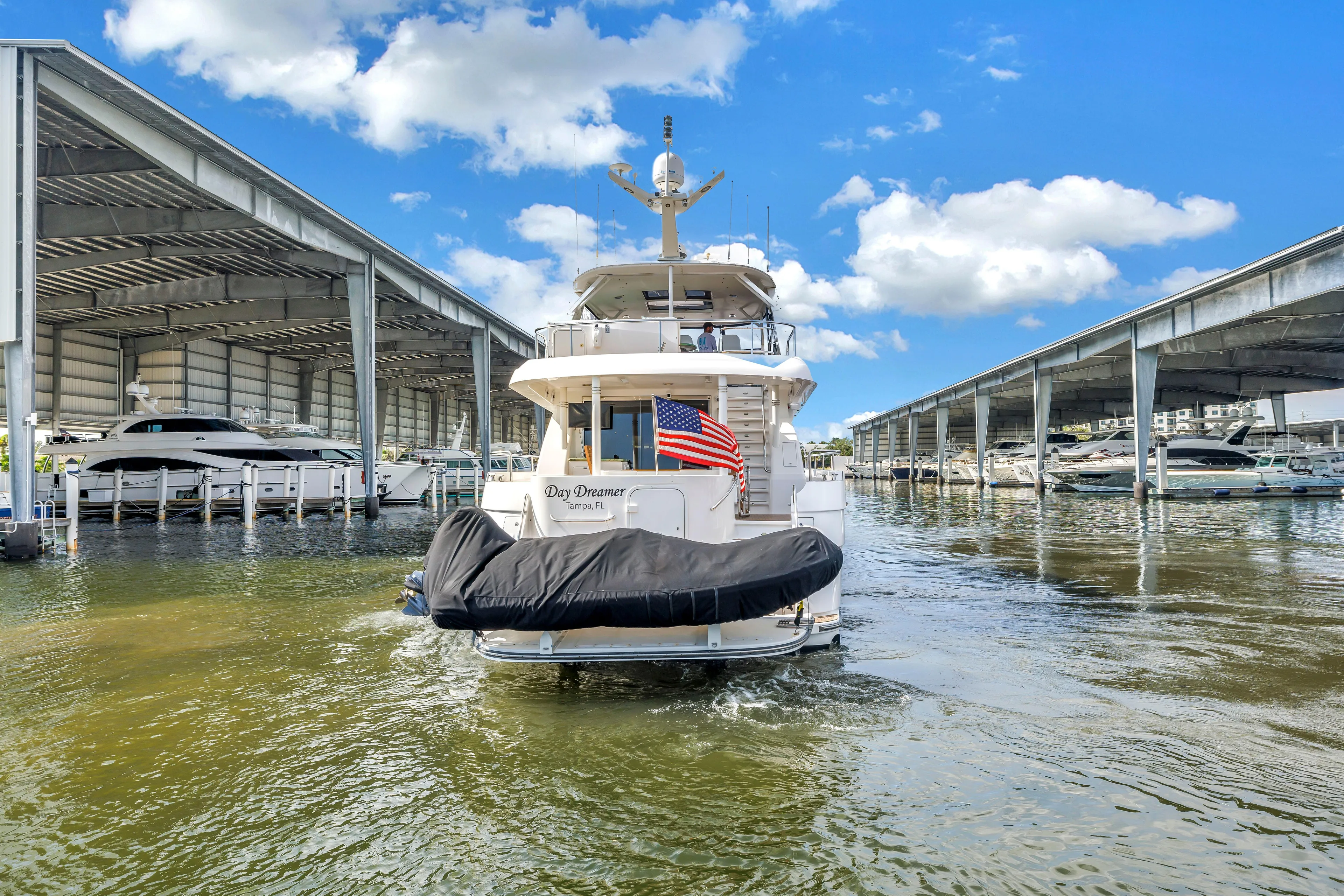  Yacht Photos Pics 2000 Neptunus 65 Flybridge yacht docked in marina, under clear blue sky.