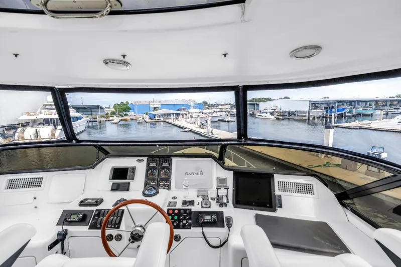  Yacht Photos Pics Flybridge helm of 2000 Neptunus 65 yacht with marina view.