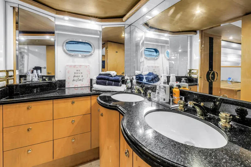  Yacht Photos Pics Luxurious bathroom in 2000 Neptunus 65 Flybridge yacht with dual sinks and elegant decor.