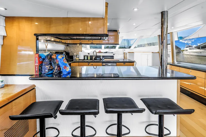  Yacht Photos Pics Luxurious Neptunus 65 Flybridge yacht interior with modern kitchen and bar seating, 2000 model.