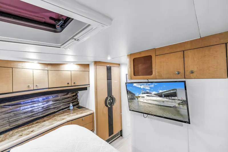  Yacht Photos Pics Interior of 2000 Neptunus 65 Flybridge yacht with TV and wooden cabinets.