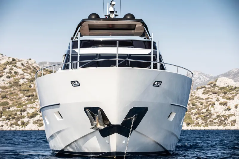  Yacht Photos Pics Sanlorenzo SL86 2017 yacht on water, front view with scenic rocky background.