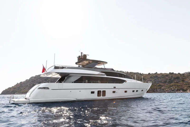  Yacht Photos Pics 2017 Sanlorenzo SL86 yacht on the water near a rocky coastline.