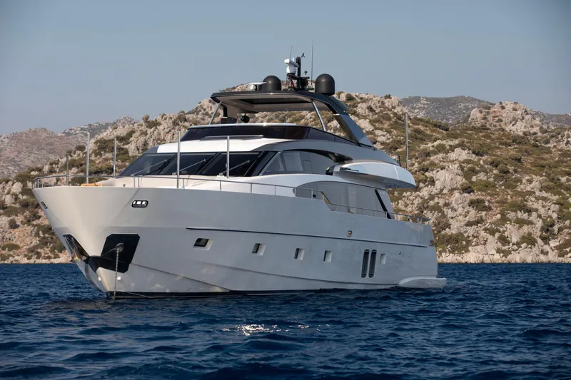  Yacht Photos Pics 2017 Sanlorenzo SL86 yacht on calm sea with rocky coastline backdrop.