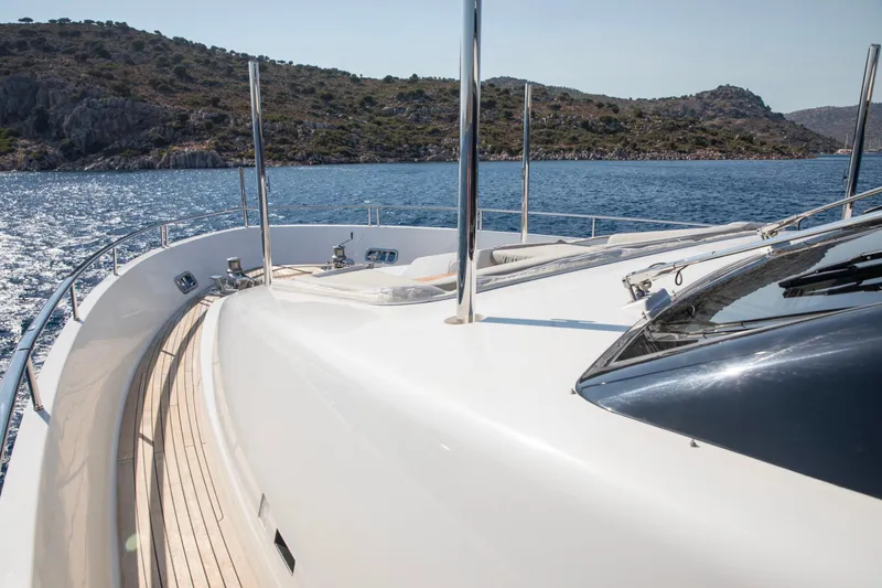  Yacht Photos Pics Luxurious 2017 Sanlorenzo SL86 yacht cruising on a serene sea with scenic hills.