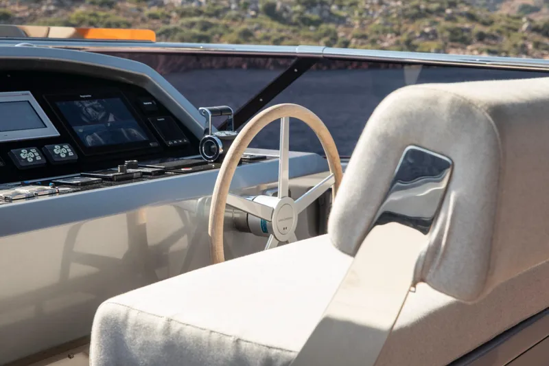  Yacht Photos Pics Helm of 2017 Sanlorenzo SL86 yacht with modern controls and wooden steering wheel.