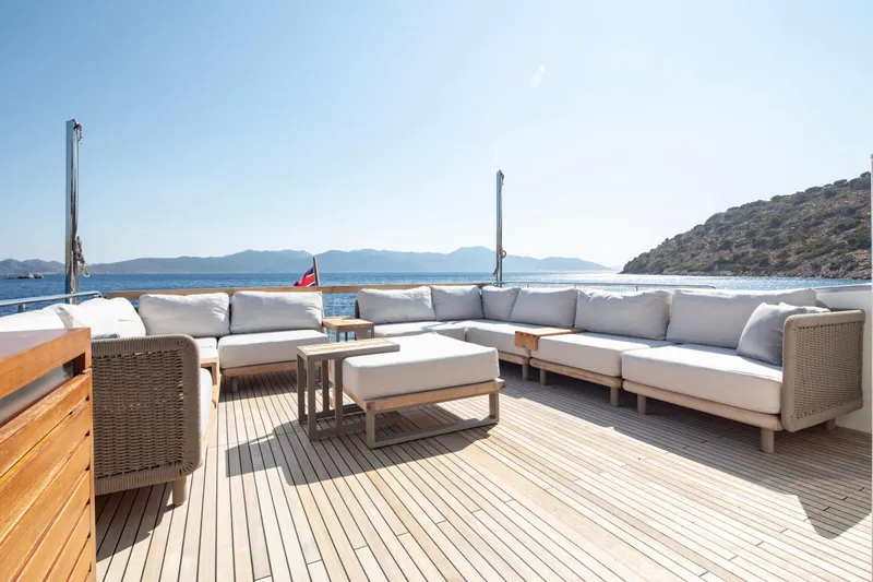  Yacht Photos Pics Luxurious Sanlorenzo SL86 yacht deck with comfortable seating, overlooking serene ocean and mountains.