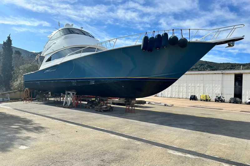 Tia Yacht Photos Pics 2017 Viking 62 Enclosed Bridge yacht on dry dock under clear blue sky.
