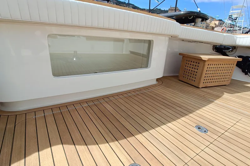 Tia Yacht Photos Pics 2017 Viking 62 Enclosed Bridge yacht deck with teak flooring and seating area.