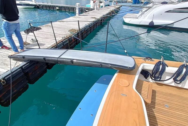 Tia Yacht Photos Pics 2017 Viking 62 Enclosed Bridge yacht docked, featuring teak deck and carbon fiber elements.