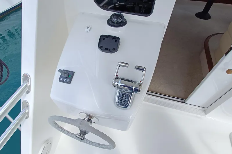 Tia Yacht Photos Pics Control panel of 2017 Viking 62 Enclosed Bridge yacht with steering wheel and throttle.