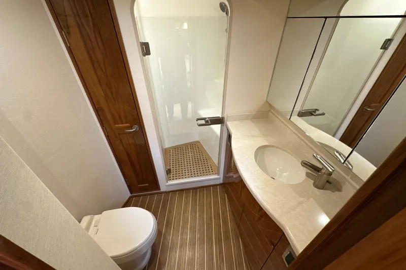 Tia Yacht Photos Pics Luxurious bathroom in 2017 Viking 62 Enclosed Bridge yacht with shower and vanity.