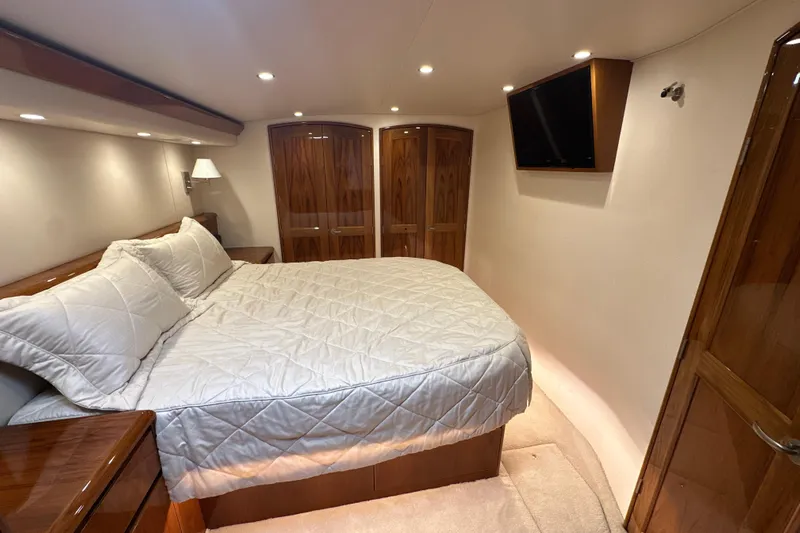 Tia Yacht Photos Pics Luxurious bedroom in 2017 Viking 62 Enclosed Bridge yacht with elegant wood finishes.