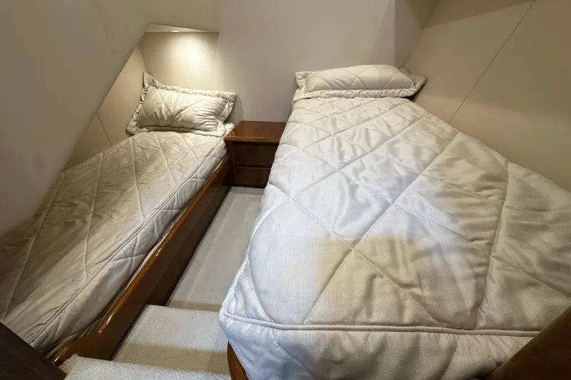 Tia Yacht Photos Pics 2017 Viking 62 Enclosed Bridge cabin with twin beds and soft lighting.