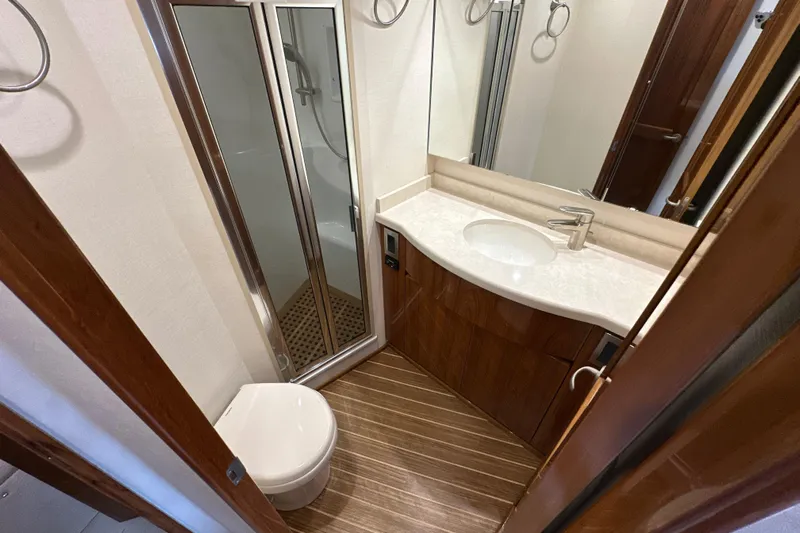 Tia Yacht Photos Pics Bathroom interior of 2017 Viking 62 Enclosed Bridge yacht with shower and sink.