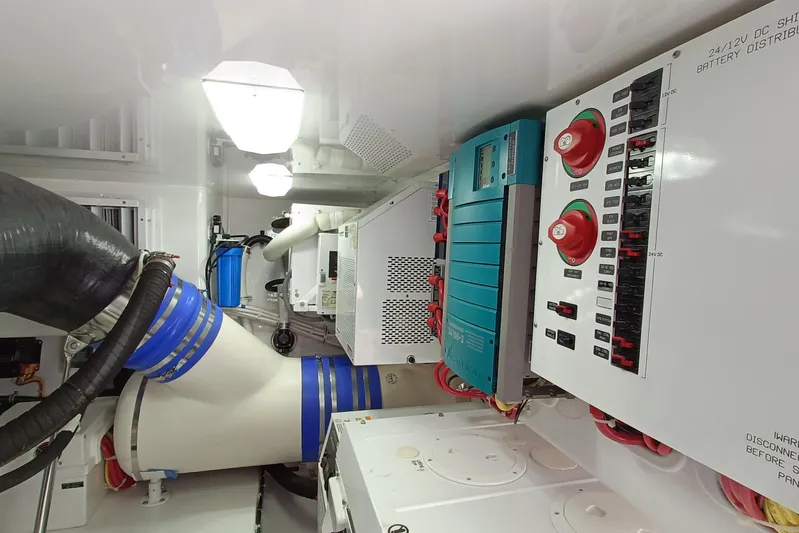Tia Yacht Photos Pics Engine room of 2017 Viking 62 Enclosed Bridge yacht, featuring electrical panels and ventilation systems.