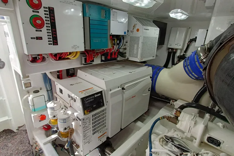 Tia Yacht Photos Pics Engine room of 2017 Viking 62 Enclosed Bridge with Cummins Onan generator and control panels.