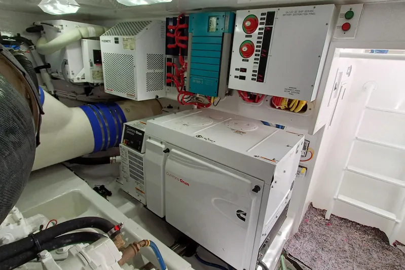 Tia Yacht Photos Pics Engine room of 2017 Viking 62 Enclosed Bridge with Cummins Onan generator and control panels.