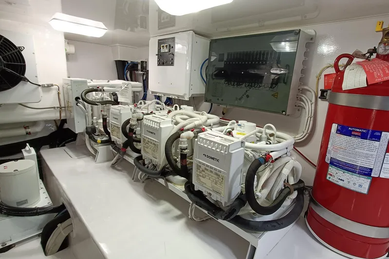 Tia Yacht Photos Pics Engine room of 2017 Viking 62 Enclosed Bridge with Dometic systems and fire extinguisher.