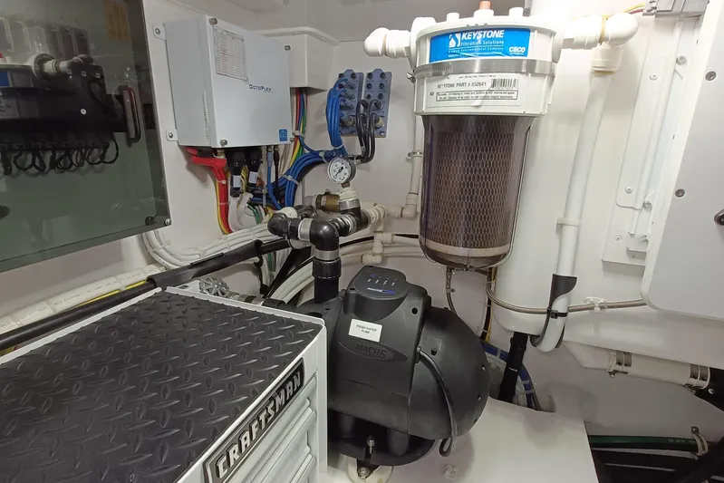 Tia Yacht Photos Pics Engine room of 2017 Viking 62 Enclosed Bridge yacht with filtration system and electrical components.